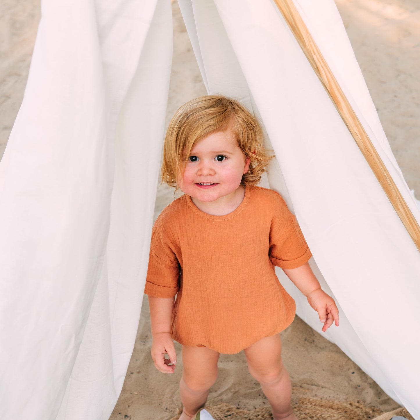 Riley Bubble Hem Organic Cotton Romper in Burnt Orange